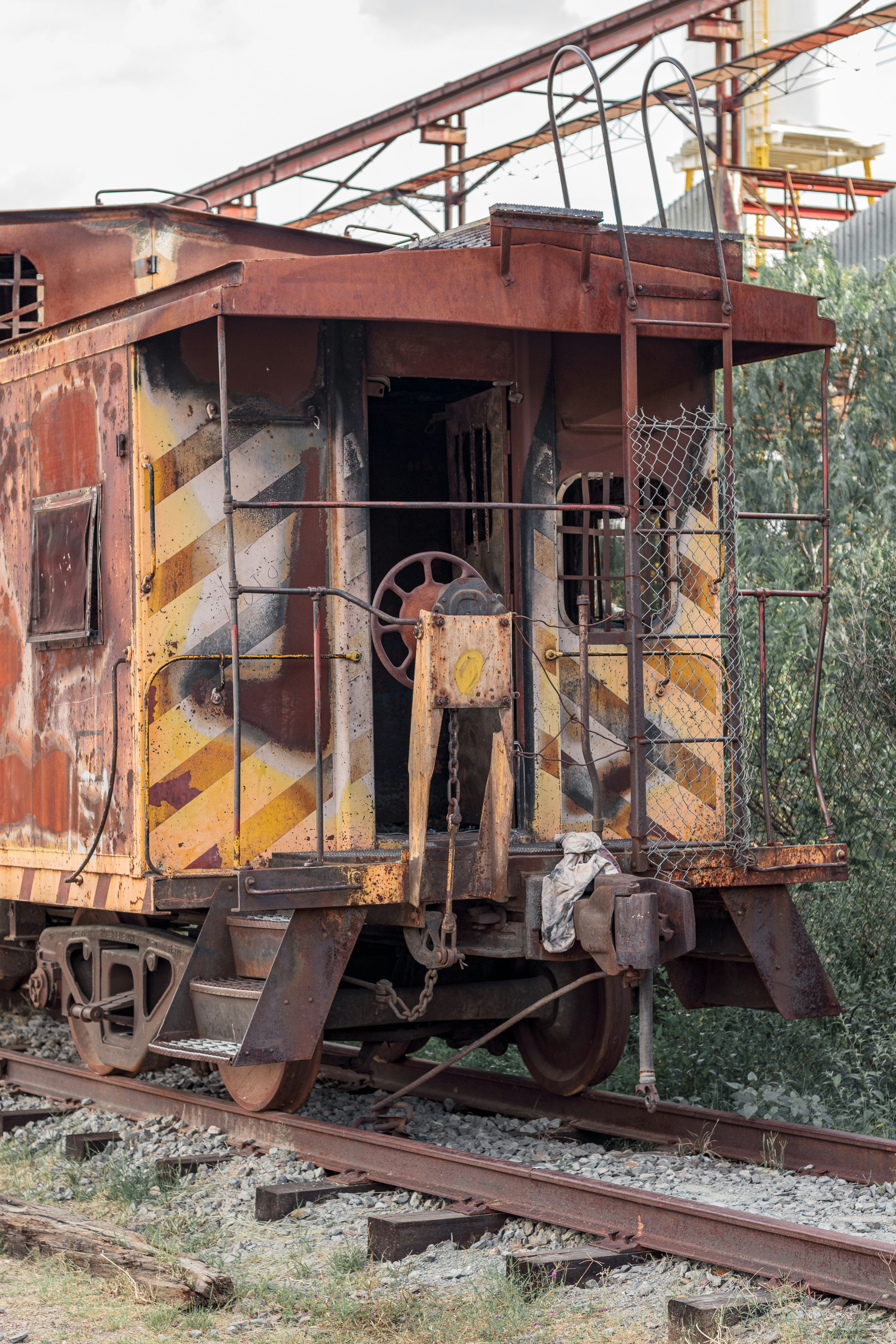 yellow and brown train on rail tracks